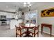 Bright dining area adjacent to kitchen, with sliding glass doors to deck at 19593 E Hollow Creek Dr, Parker, CO 80134