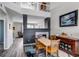 Open dining room with hardwood floors, fireplace, and view of the upper level landing at 19593 E Hollow Creek Dr, Parker, CO 80134