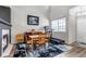 Bright dining area with modern accents, featuring a fireplace and large window with scenic views at 19593 E Hollow Creek Dr, Parker, CO 80134
