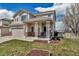 Well-maintained home featuring a cozy front porch and a neatly landscaped front yard at 19593 E Hollow Creek Dr, Parker, CO 80134