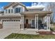 Inviting home exterior with a cozy front porch featuring stylish seating and red brick accents at 19593 E Hollow Creek Dr, Parker, CO 80134