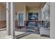 Cozy front porch with stylish wicker seating, brick accents, and a welcoming entrance at 19593 E Hollow Creek Dr, Parker, CO 80134