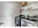 Modern laundry room featuring front load washer/dryer and ample shelving at 19593 E Hollow Creek Dr, Parker, CO 80134