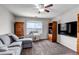 Living room featuring neutral walls, plush carpet, ceiling fan, large window and nice furnishings at 19593 E Hollow Creek Dr, Parker, CO 80134