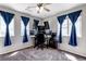 Office with multiple monitors and windows with blue curtains at 19593 E Hollow Creek Dr, Parker, CO 80134