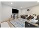 Cozy finished basement featuring a sectional couch, TV, and decorative carpet at 6760 Mariposa Ct, Denver, CO 80221