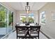 Dining room with sliding glass doors to the backyard, lots of light, and a modern light fixture at 6760 Mariposa Ct, Denver, CO 80221