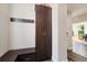 Entryway with built-in storage cabinets and a bench, conveniently located near the front door at 6760 Mariposa Ct, Denver, CO 80221