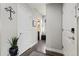 Hallway with hardwood floors that includes views into other rooms and a plant to add some color at 6760 Mariposa Ct, Denver, CO 80221