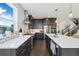Bright kitchen with stainless steel appliances, a brick backsplash, and island seating at 6760 Mariposa Ct, Denver, CO 80221