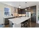 Modern kitchen with stainless steel appliances, brick backsplash, and island seating at 6760 Mariposa Ct, Denver, CO 80221