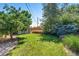 Lush backyard with a small storage shed, well-kept lawn, and privacy fence at 4660 E Briarwood Pl, Centennial, CO 80122