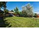 Large, well-maintained backyard with mature trees and lush green grass at 4660 E Briarwood Pl, Centennial, CO 80122