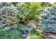Backyard water feature surrounded by greenery and rockery at 4660 E Briarwood Pl, Centennial, CO 80122
