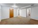 Spacious basement with neutral carpet and a large entryway at 4660 E Briarwood Pl, Centennial, CO 80122