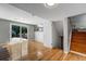 Spacious finished basement area featuring hardwood floors, neutral paint, and sliding glass door to backyard at 4660 E Briarwood Pl, Centennial, CO 80122