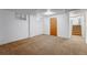Basement featuring neutral carpet, egress window, and access to the stairs at 4660 E Briarwood Pl, Centennial, CO 80122