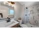 Stylish bathroom with marble tiled shower, modern vanity, and elegant fixtures at 4660 E Briarwood Pl, Centennial, CO 80122