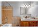 Bathroom with tiled shower, vanity, and a stylish mirror at 4660 E Briarwood Pl, Centennial, CO 80122