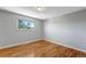 Bedroom features hardwood floors, light-filled window, and neutral paint at 4660 E Briarwood Pl, Centennial, CO 80122