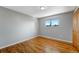 Bright bedroom featuring gleaming hardwood floors and a sunny window at 4660 E Briarwood Pl, Centennial, CO 80122