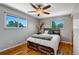 This bedroom boasts hardwood floors, neutral paint, and two windows for natural light and a built-in headboard at 4660 E Briarwood Pl, Centennial, CO 80122
