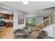 Open-concept dining area leading to a modern kitchen, a cozy living room, and stairway at 4660 E Briarwood Pl, Centennial, CO 80122