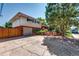 Spacious two-story house with a large driveway, brick accents, and mature trees surrounding the property at 4660 E Briarwood Pl, Centennial, CO 80122