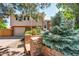 Charming two-story home featuring a brick facade, well-maintained landscaping, and an attached garage at 4660 E Briarwood Pl, Centennial, CO 80122