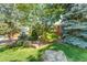Landscaped front yard featuring mature trees and flowering bushes at 4660 E Briarwood Pl, Centennial, CO 80122