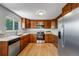 Updated kitchen with wood cabinets, stainless steel appliances, and a window view at 4660 E Briarwood Pl, Centennial, CO 80122