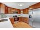 Well-lit kitchen with stainless steel appliances, wood cabinets and light counter tops at 4660 E Briarwood Pl, Centennial, CO 80122