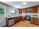 Bright kitchen featuring wood cabinets, stainless steel appliances, and hardwood floors at 4660 E Briarwood Pl, Centennial, CO 80122