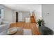 Hardwood floors and neutral paint throughout this bright living room with easy access to the stairway at 4660 E Briarwood Pl, Centennial, CO 80122