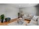 Spacious living room boasts hardwood floors, neutral paint and plush seating area with plants at 4660 E Briarwood Pl, Centennial, CO 80122
