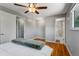This bright main bedroom features a ceiling fan, hardwood floors, and en suite bathroom at 4660 E Briarwood Pl, Centennial, CO 80122
