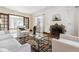 Bright living room featuring a brick fireplace, neutral furniture, and a glass-topped coffee table, perfect for relaxation at 1137 S Gilpin St, Denver, CO 80210