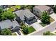 Aerial view of a green home with a large driveway, three-car garage, and well-manicured lawn at 9772 Clairton Pl, Highlands Ranch, CO 80126