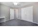 Neutral bedroom features a ceiling fan, gray carpet, large closet and white trim throughout at 9772 Clairton Pl, Highlands Ranch, CO 80126