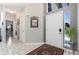 Welcoming foyer with white tile floor, high ceilings, and a red oriental rug by the front door at 9772 Clairton Pl, Highlands Ranch, CO 80126