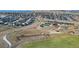 An elevated view of a planned community with a pool, playground, and open green space surrounded by residences at 6055 Point Rider Cir, Castle Rock, CO 80104