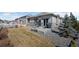 Cozy backyard featuring a concrete patio, grill, and low-maintenance gravel landscaping at 6055 Point Rider Cir, Castle Rock, CO 80104