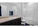 Well-lit bathroom features a shower-tub, vanity with sink, and mirror at 6055 Point Rider Cir, Castle Rock, CO 80104