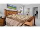 Bedroom featuring a wooden bed frame, soft bedding, and an adjacent bathroom with a glass-enclosed shower at 6055 Point Rider Cir, Castle Rock, CO 80104