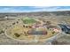 Aerial view of the community park, including a tennis court, playground, and open grassy areas at 6055 Point Rider Cir, Castle Rock, CO 80104