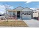 Charming single-Gathering home featuring a stone facade and two-car garage in a well-kept neighborhood at 6055 Point Rider Cir, Castle Rock, CO 80104