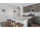 Modern kitchen featuring a large island with bar seating, granite countertops, and stainless steel appliances at 6055 Point Rider Cir, Castle Rock, CO 80104