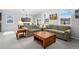 Bright living room with carpeted floors, neutral walls, and two comfortable sofas under ample natural light at 6055 Point Rider Cir, Castle Rock, CO 80104