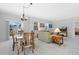 Well-lit open living space with a dining table, a comfortable sofa, and large windows providing ample natural light at 6055 Point Rider Cir, Castle Rock, CO 80104