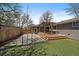 Beautiful backyard featuring a well-kept lawn, wooden deck with pergola, and mature trees at 1746 Shavano St, Longmont, CO 80504